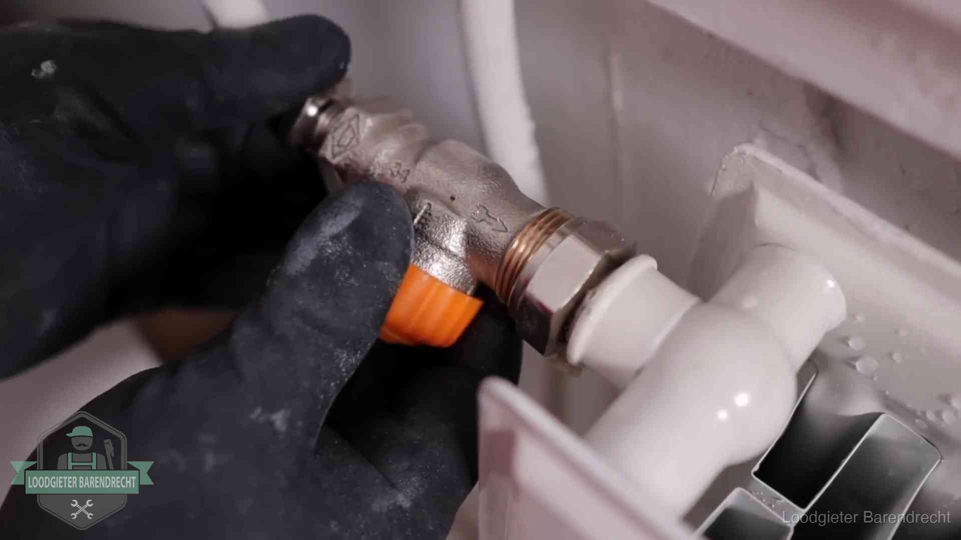 Thermostaatkraan wordt gemonteerd op een radiator in Barendrecht voor het stookseizoen